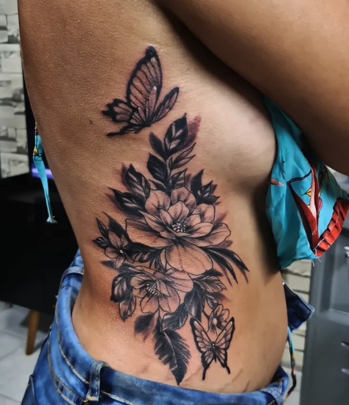 Black and grey florals and butterfly tattoo