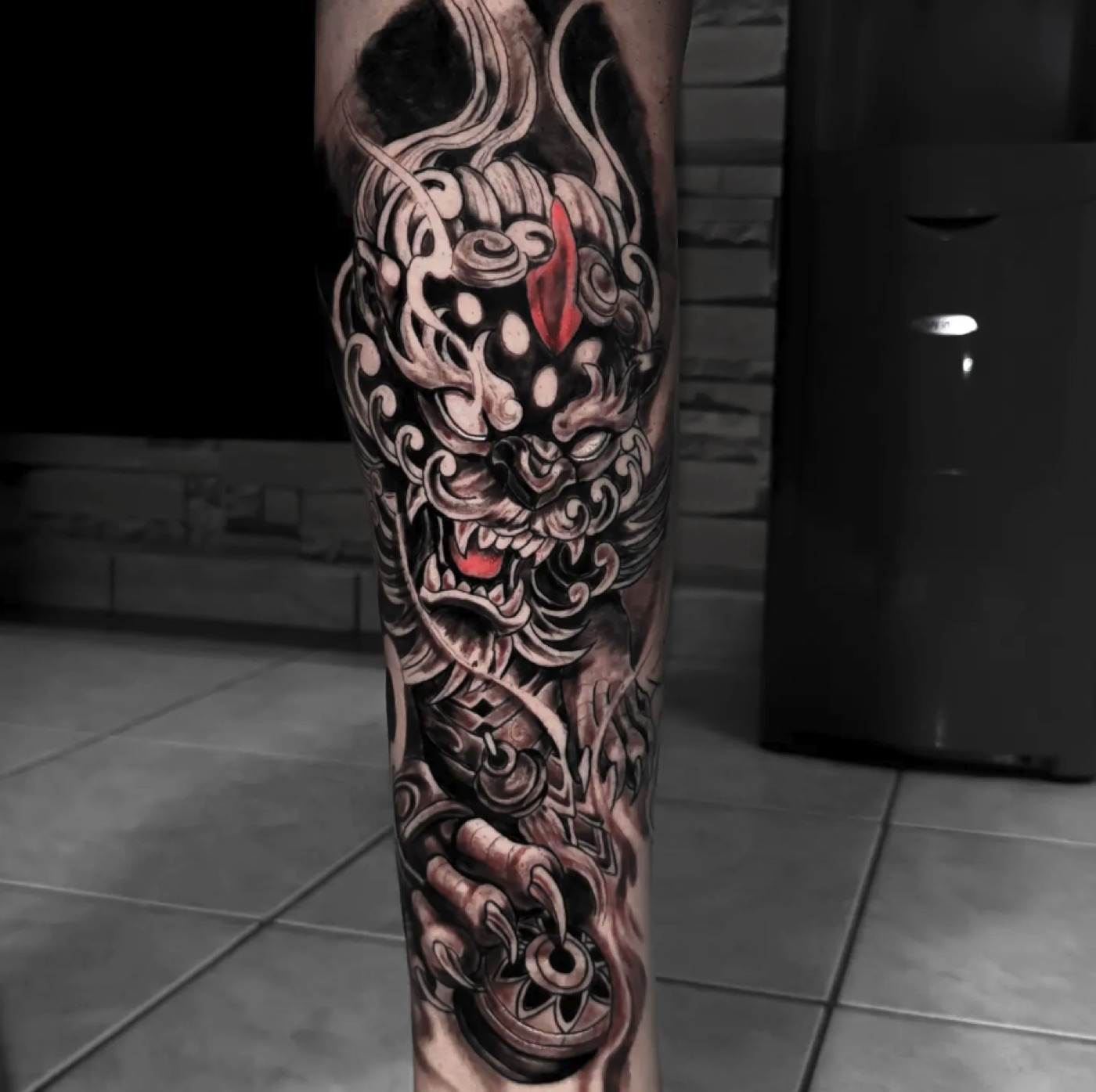 Black and grey foo dog sleeve tattoo