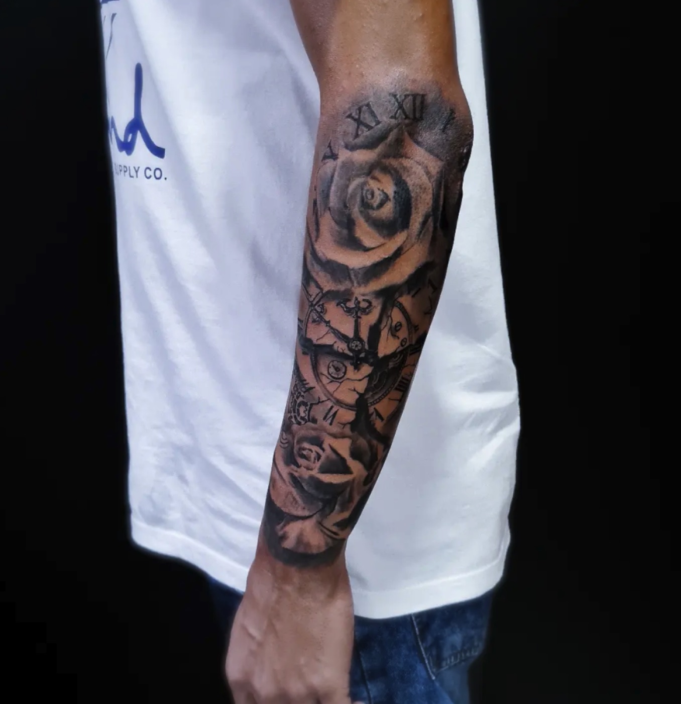 Black and grey rose sleeve tattoo