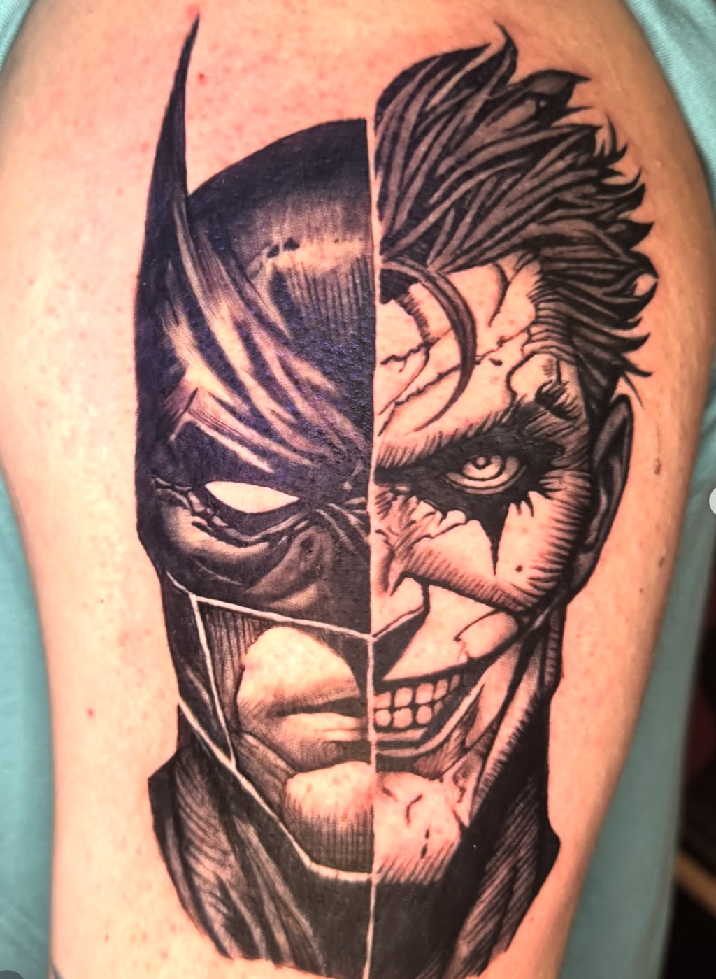 Black and grey Batman and Joker split face tattoo