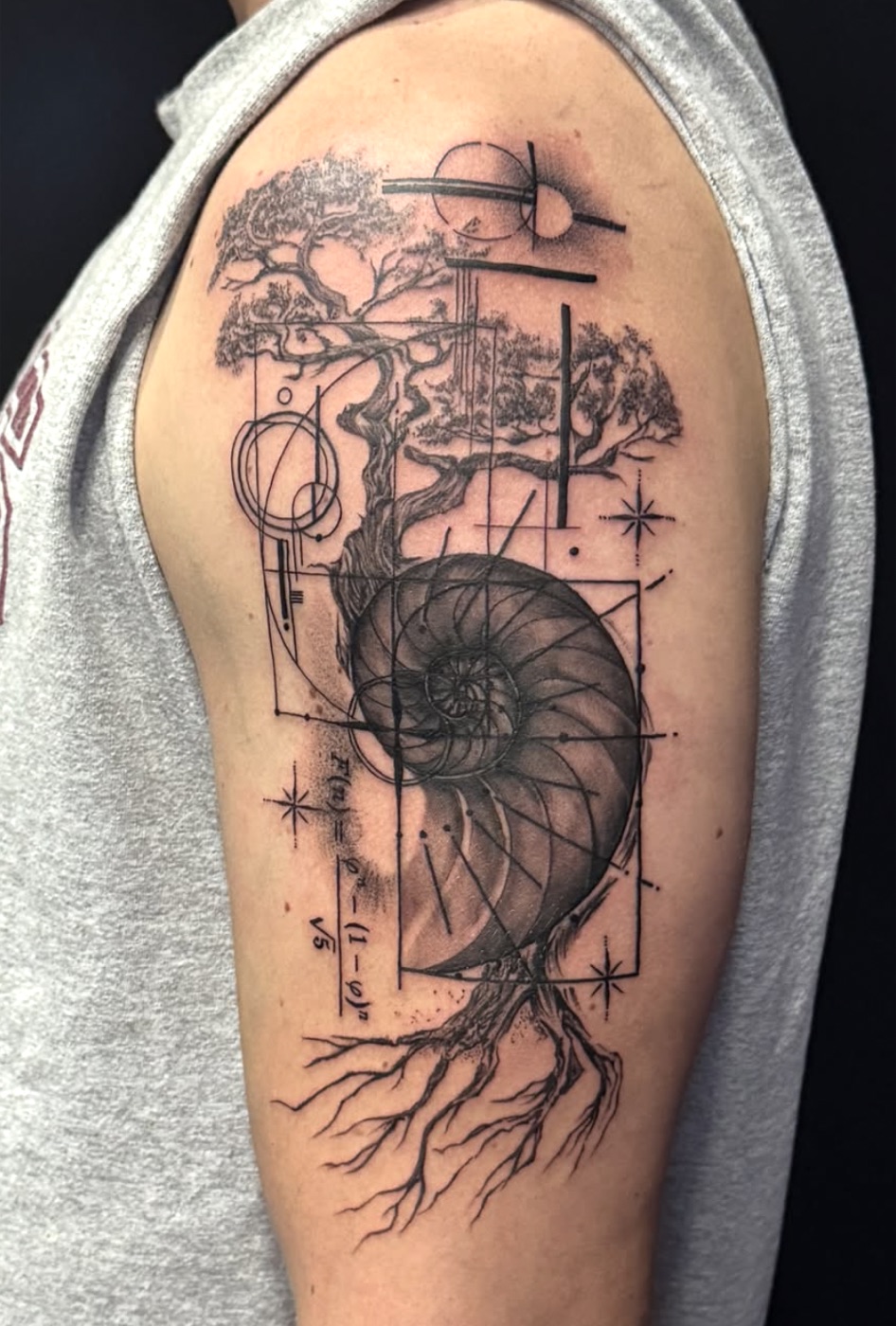 Black and grey nautilus and bonsai geometric tattoo