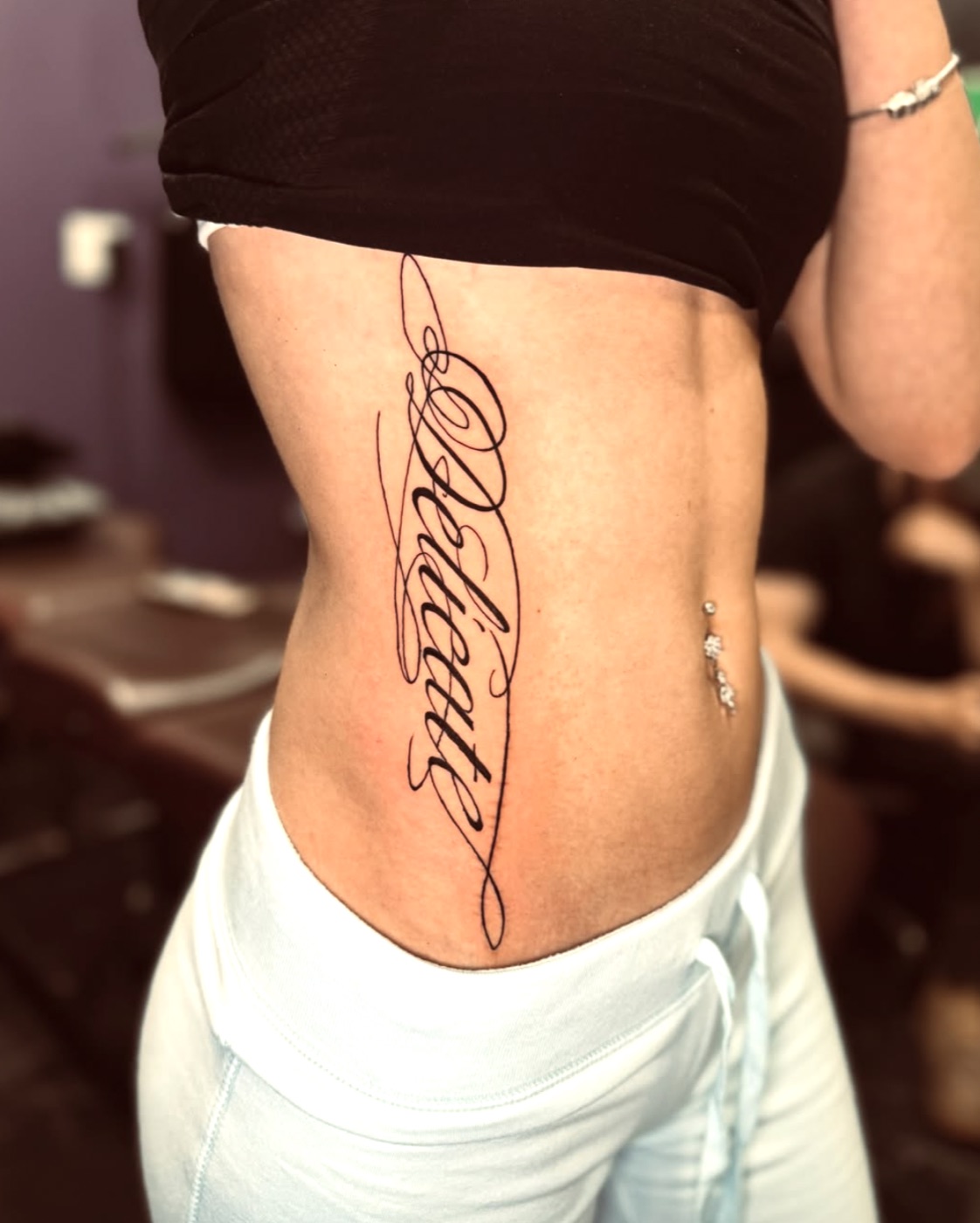 Black and grey lotus and laurel tattoo