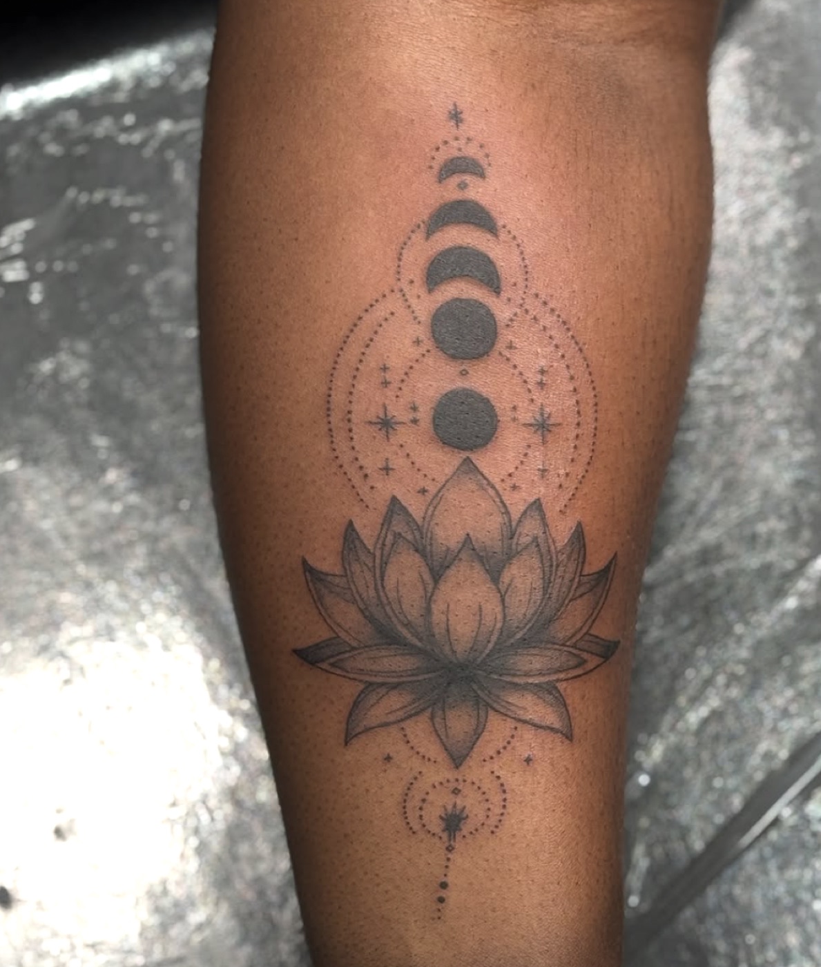 Fine line moon phases and lotus tattoo