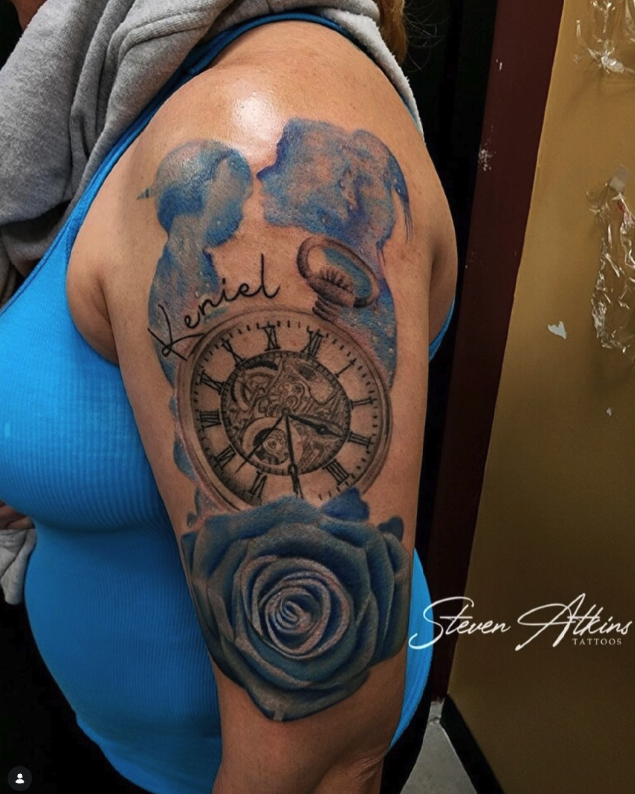 Black and grey clock and rose sleeve tattoo