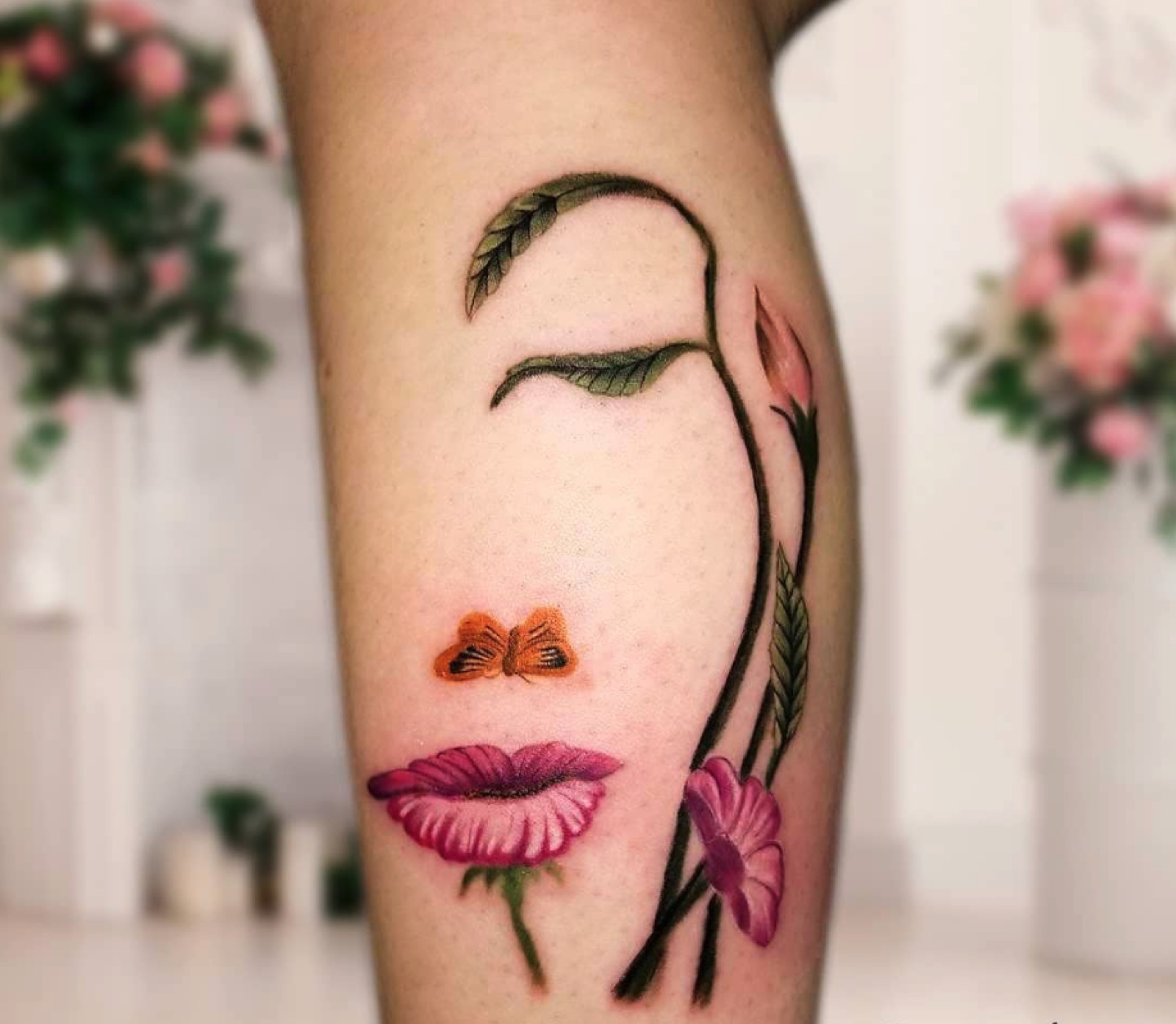 Fine line floral and face tattoo