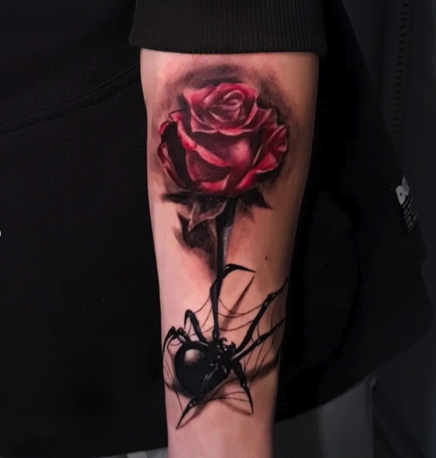 Realistic red rose with black widow spider tattoo