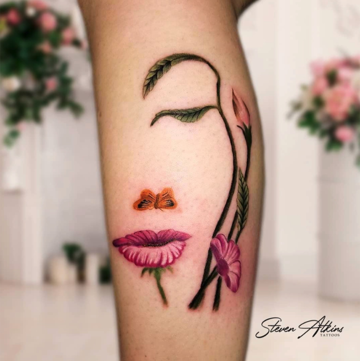 Fine line floral and face tattoo