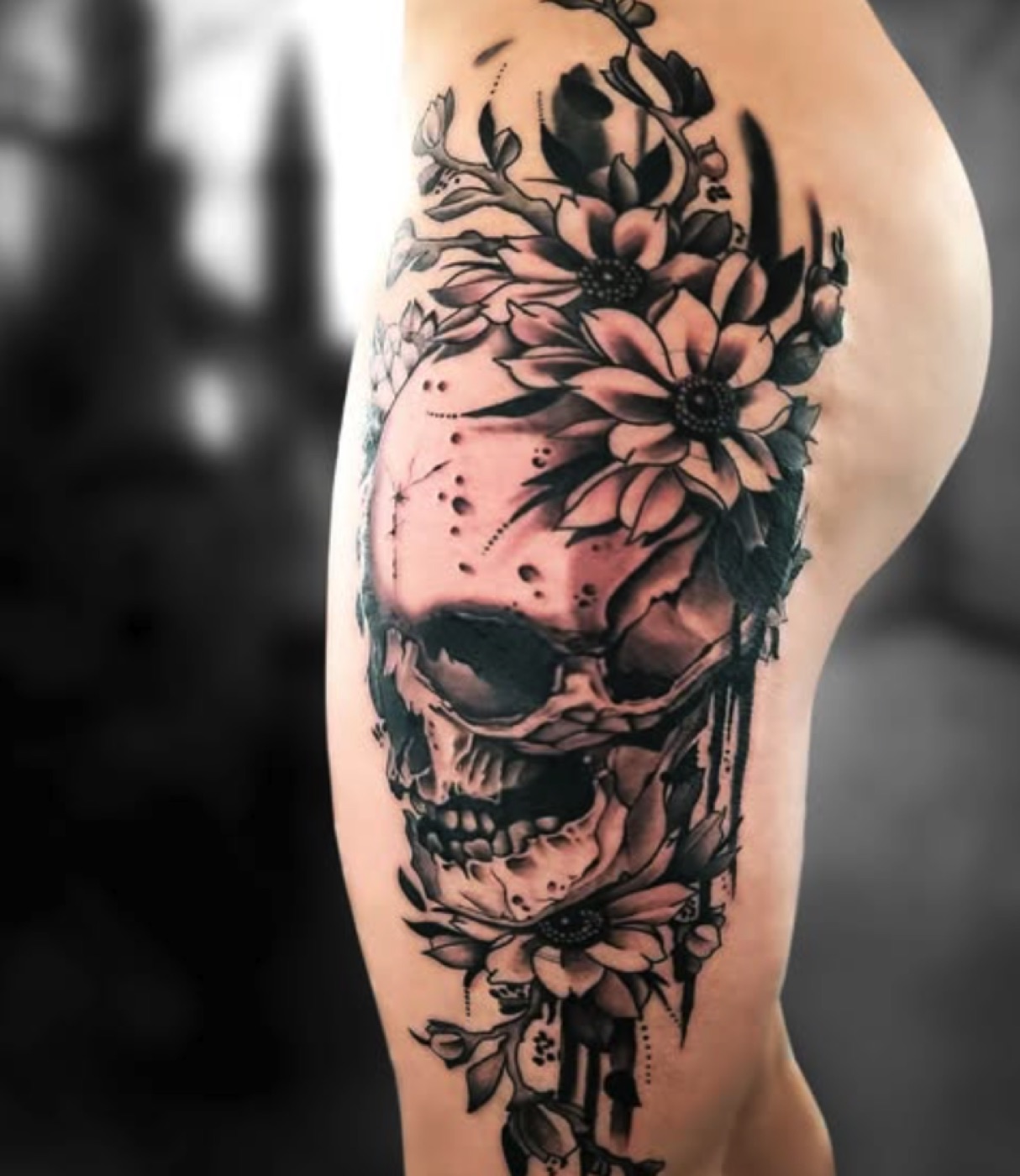 Skull and flowers black and grey tattoo