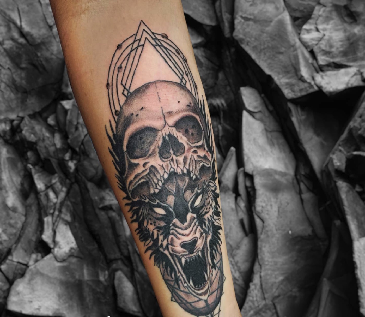 Black and grey skull and wolf tattoo